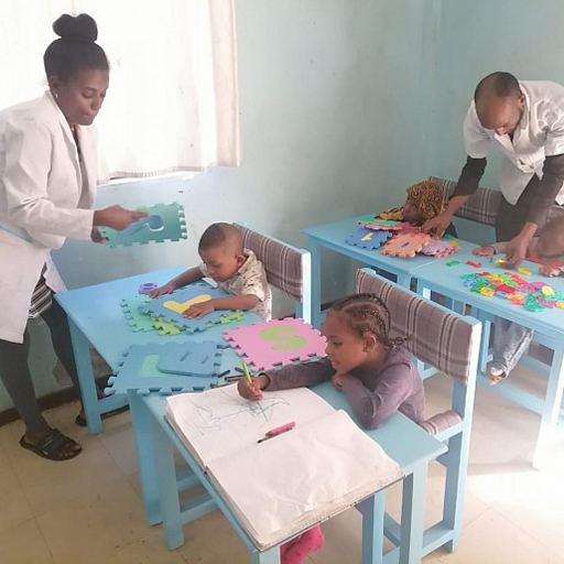 A teacher and teaching assistant with the class