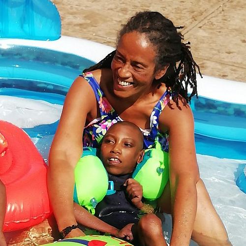 Endalew laughing in the pool during water therapy with Mena