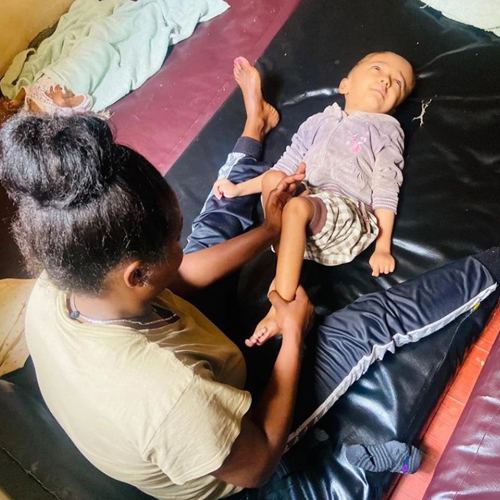 Staff giving a child a massage