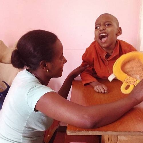 Kalab smiling with a carer